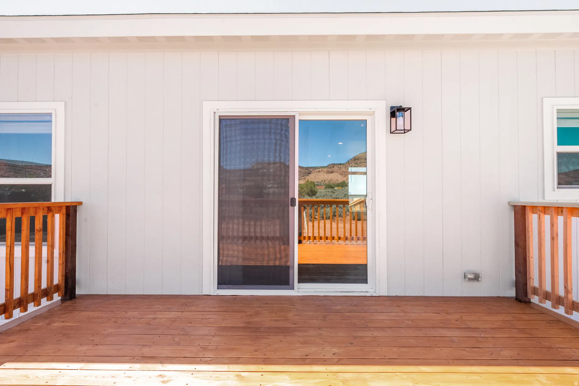 Spacious outdoor deck featuring wood-finish flooring and sturdy wood railings