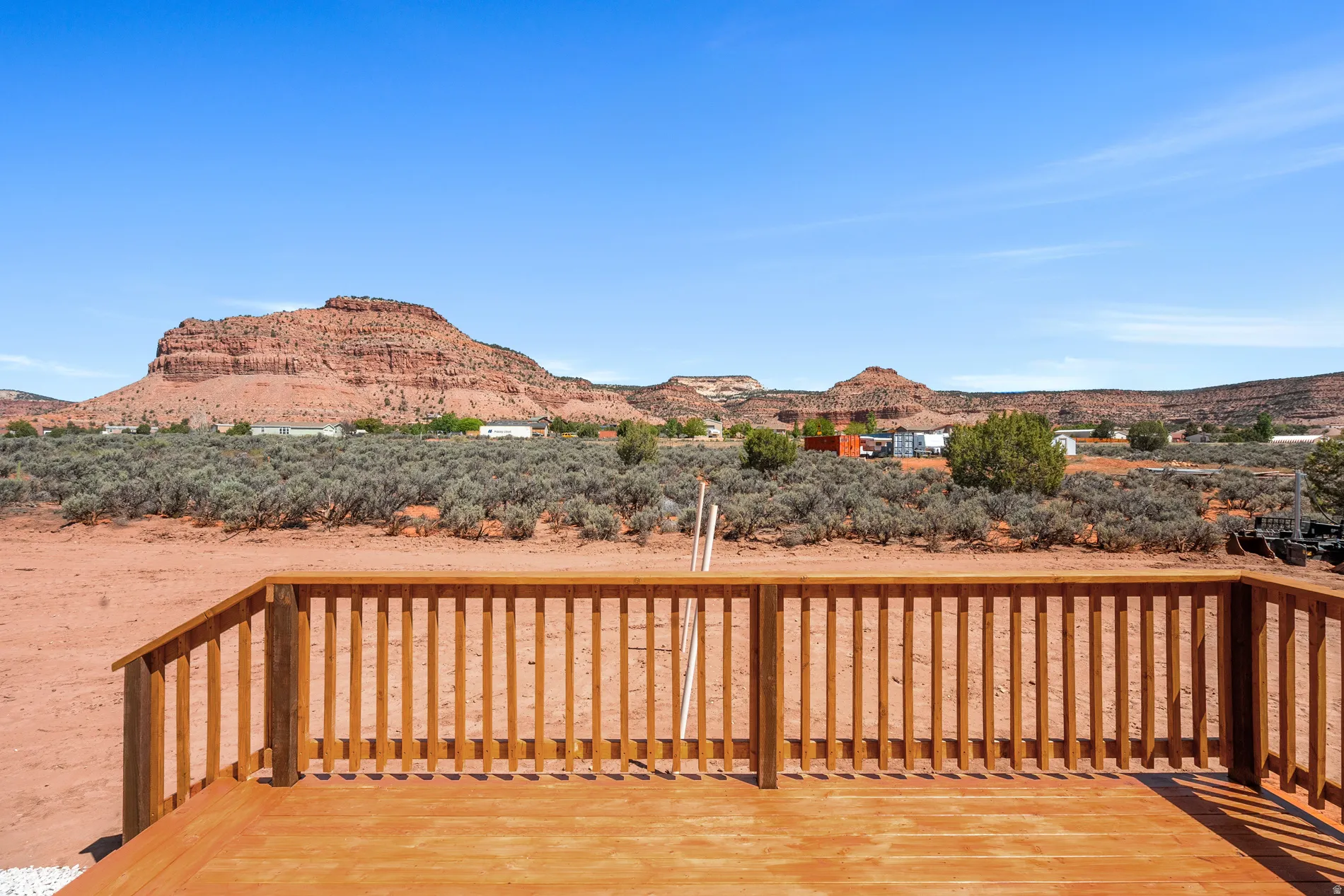 Expansive outdoor deck with natural wood railing and decking