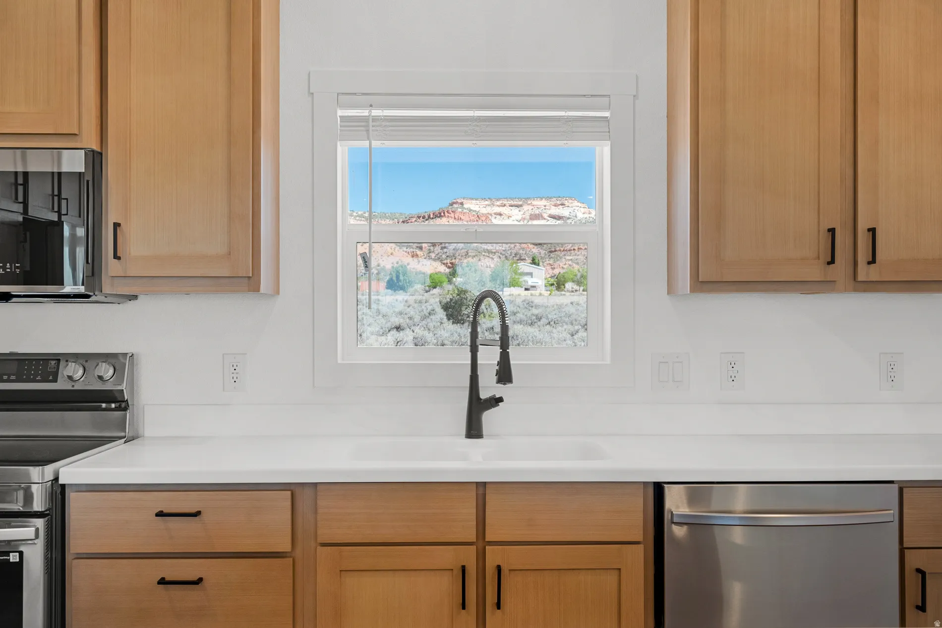 Kitchen sink with a matte black gooseneck faucet