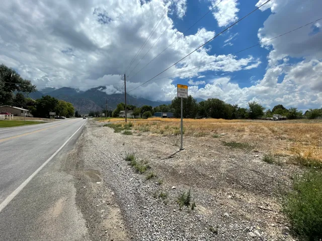 Expansive undeveloped lot featuring a natural ground cover and distant mountain backdrop