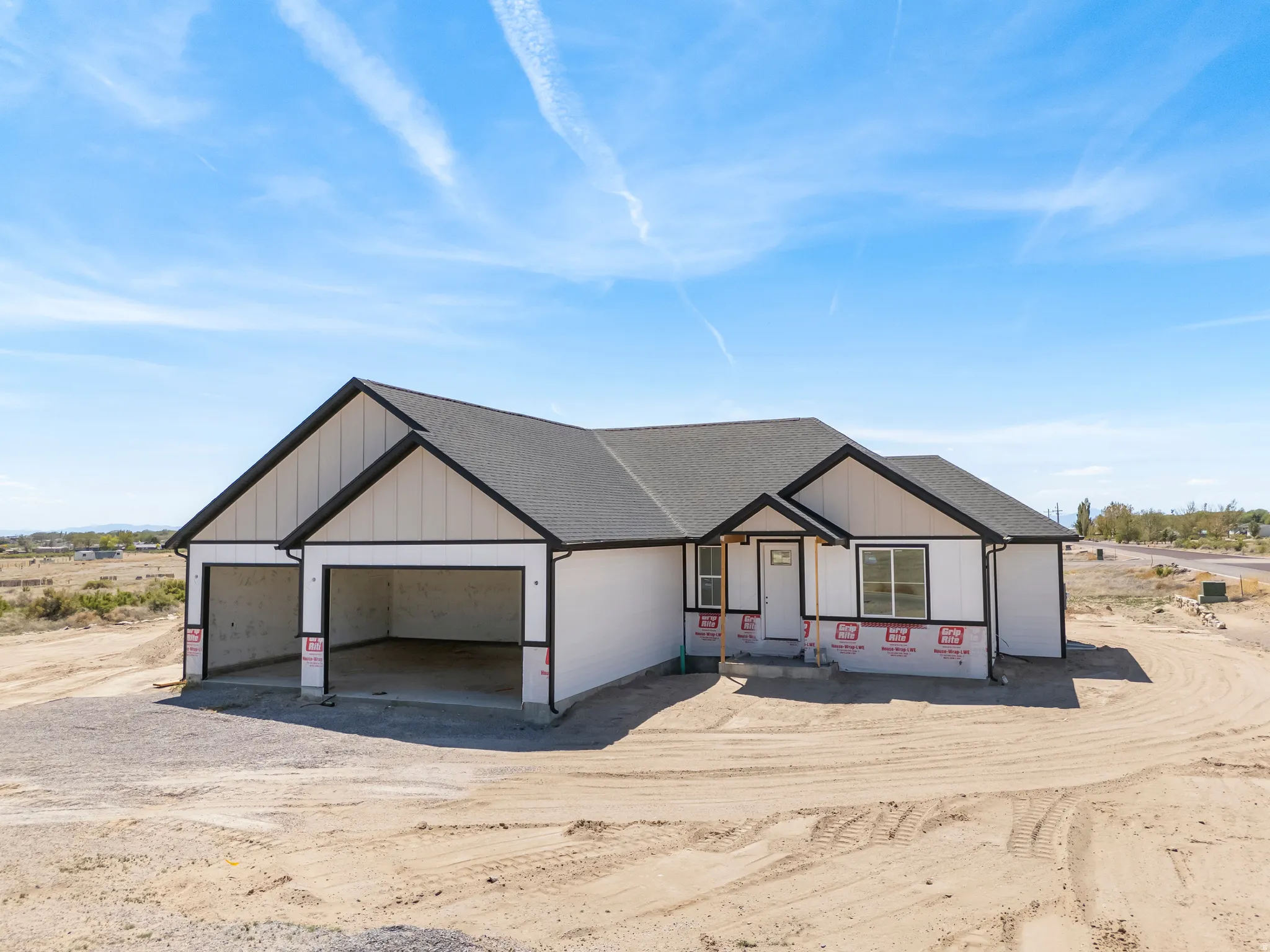 Modern farmhouse style exterior featuring white siding, black trim, and a dark shingle roof