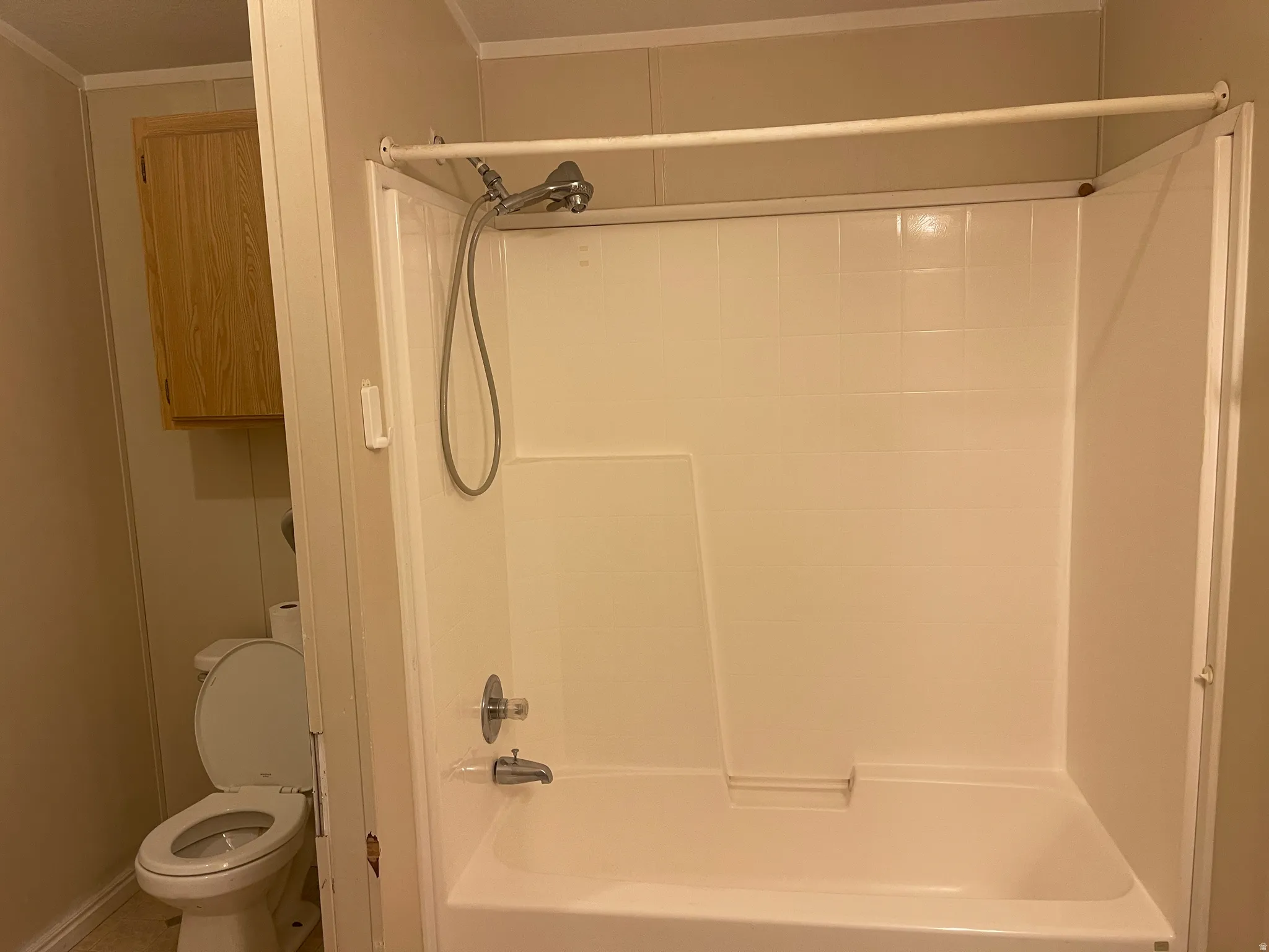 Primary Bathtub and shower combination featuring a white surround and chrome fixtures