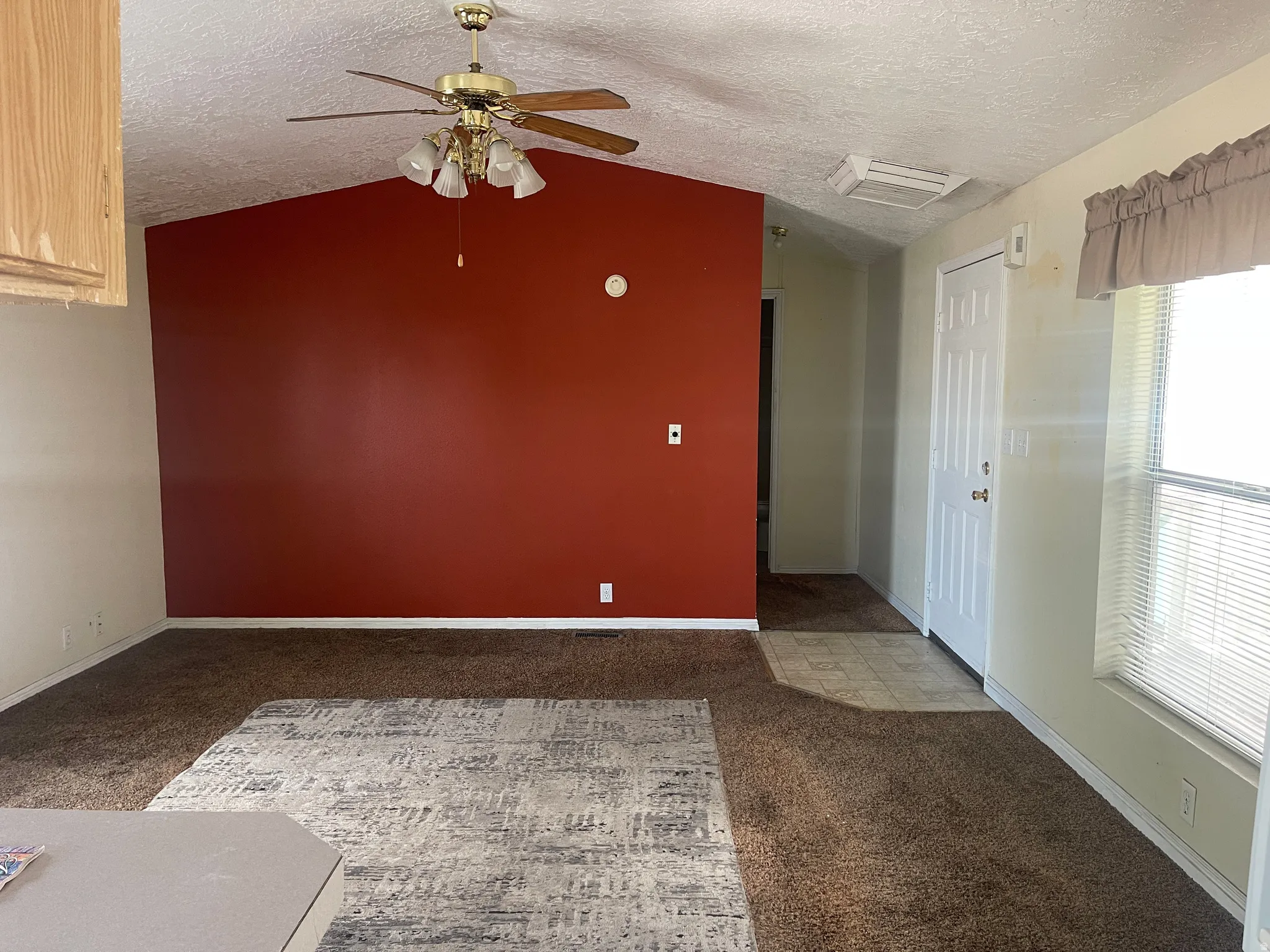 Varying ceiling heights define this interior space, featuring a vaulted ceiling in the main area and a flat ceiling towards the entry