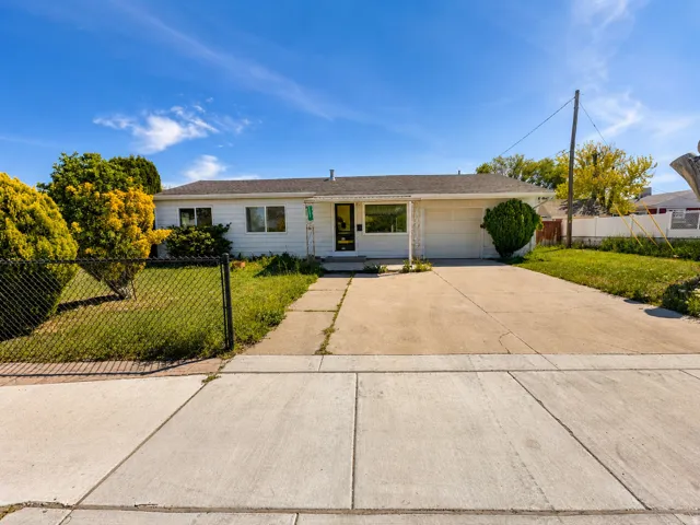 Single-story residence featuring a white exterior, a single-car garage, and a concrete driveway