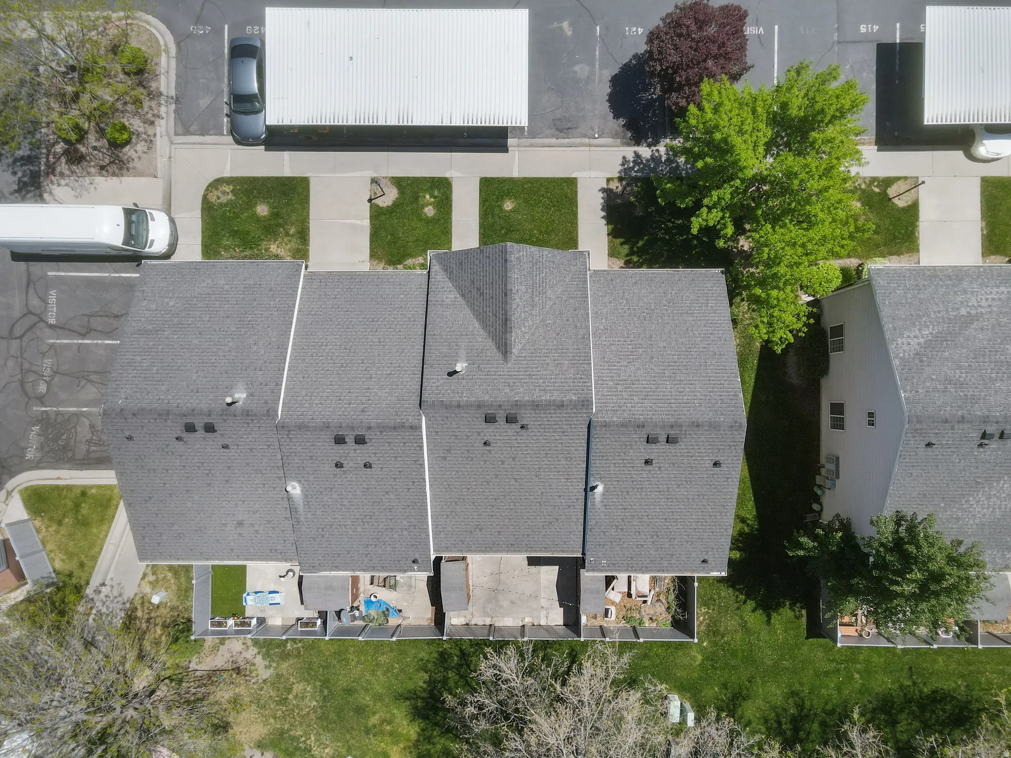 Townhome units featuring asphalt shingle roofs and private patio areas