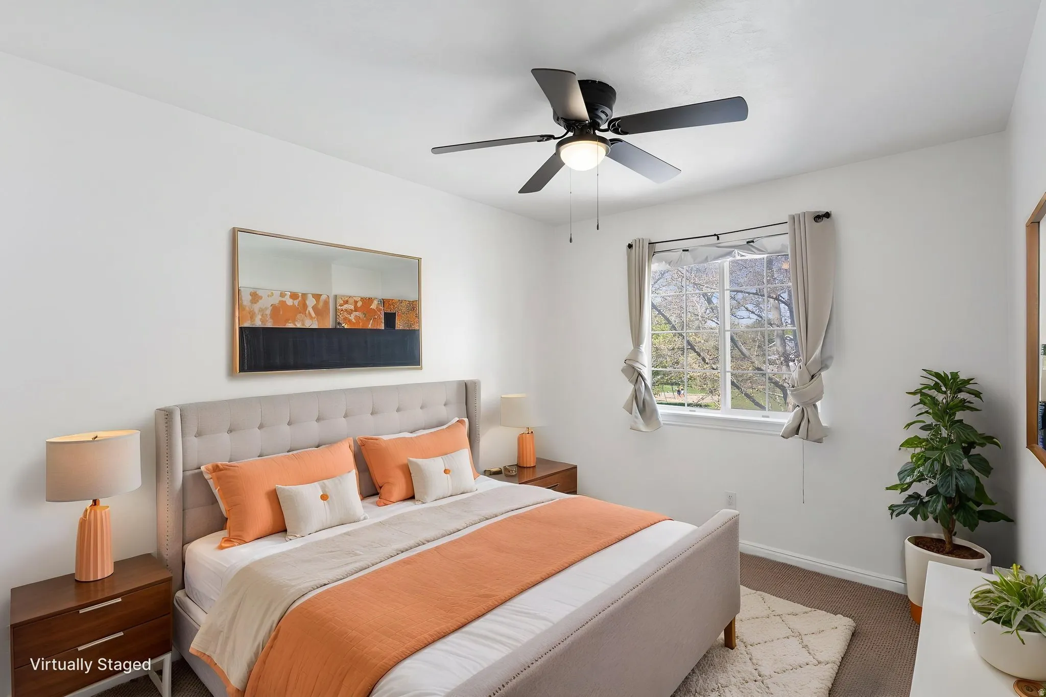 2nd Bedroom (same room as office photo, Virtually staged) Light-filled bedroom featuring a large window, neutral wall tones, a ceiling fan with integrated lighting, and carpet flooring