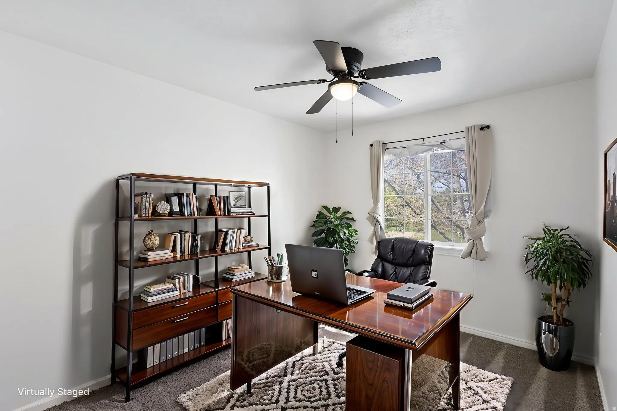 Office/Bedroom (Virtually staged) Bright room with a ceiling fan light fixture, a window, and carpet flooring