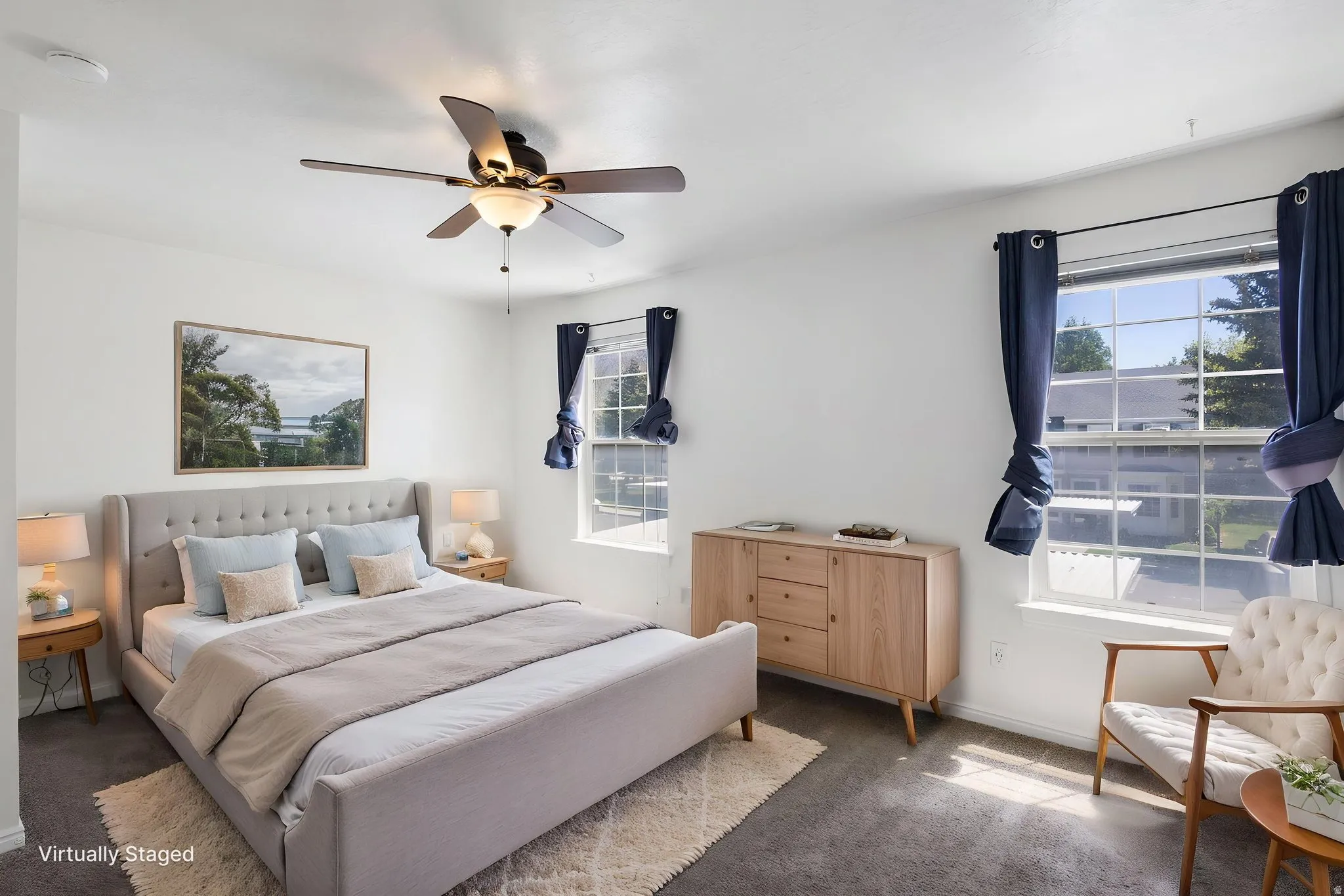 Main Bedroom (Virtually staged) Bright bedroom featuring expansive windows, a ceiling fan with integrated lighting, and neutral wall tones