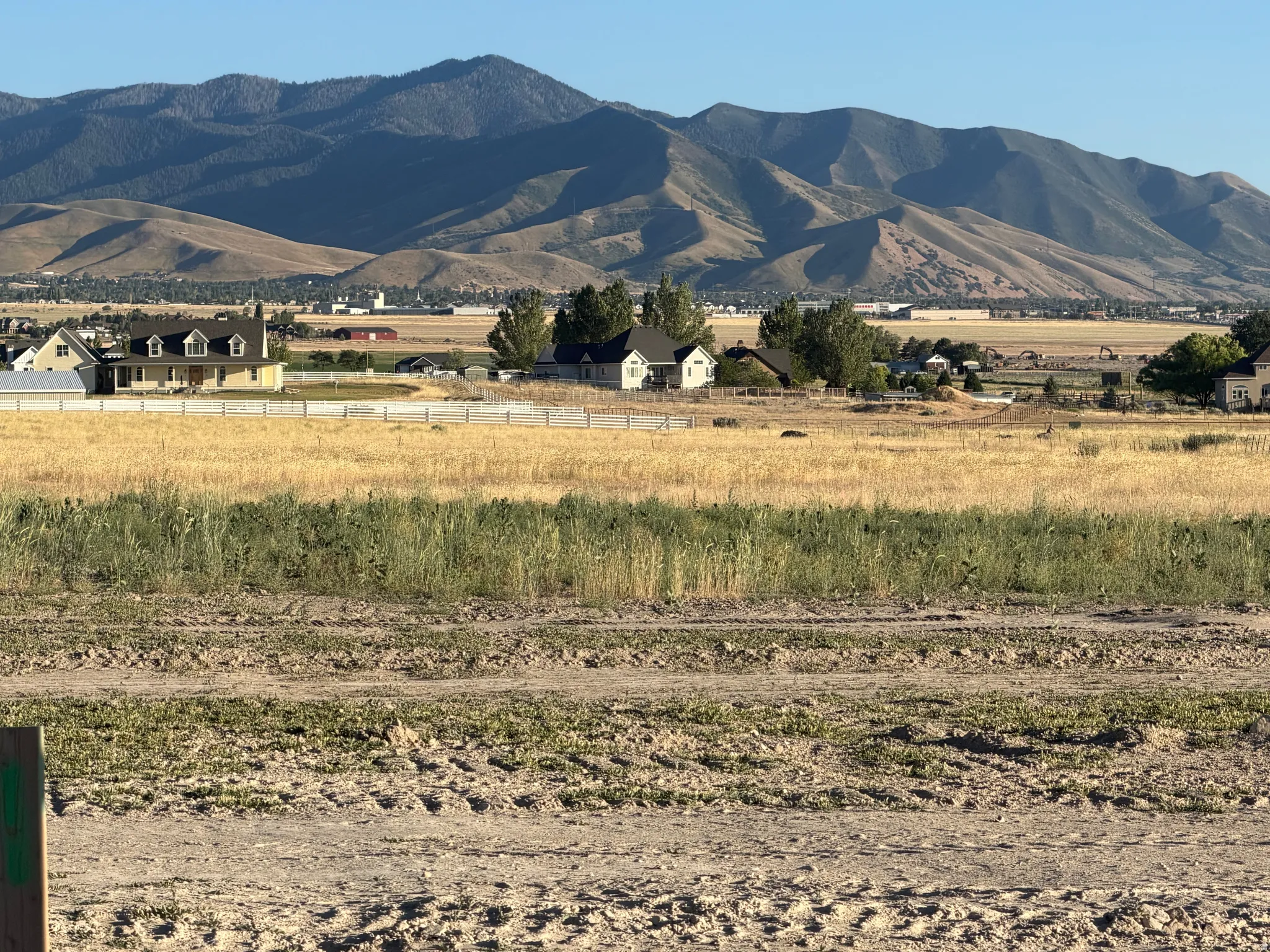 Expansive mountainous backdrop framing a developing landscape