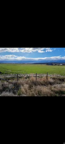 View of mountain background with rural landscape and agricultural land
