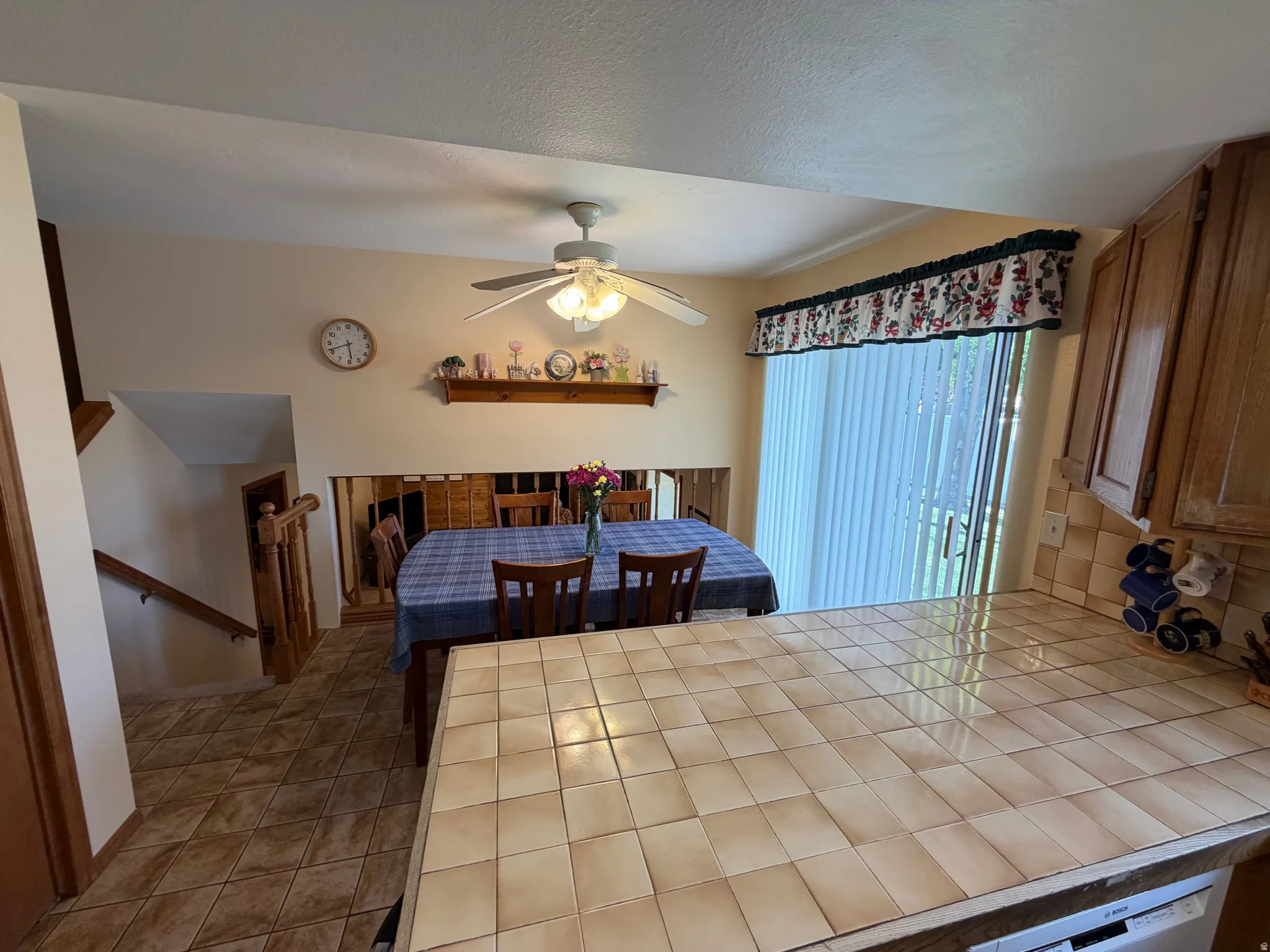 Kitchen counter featuring square ceramic tiling