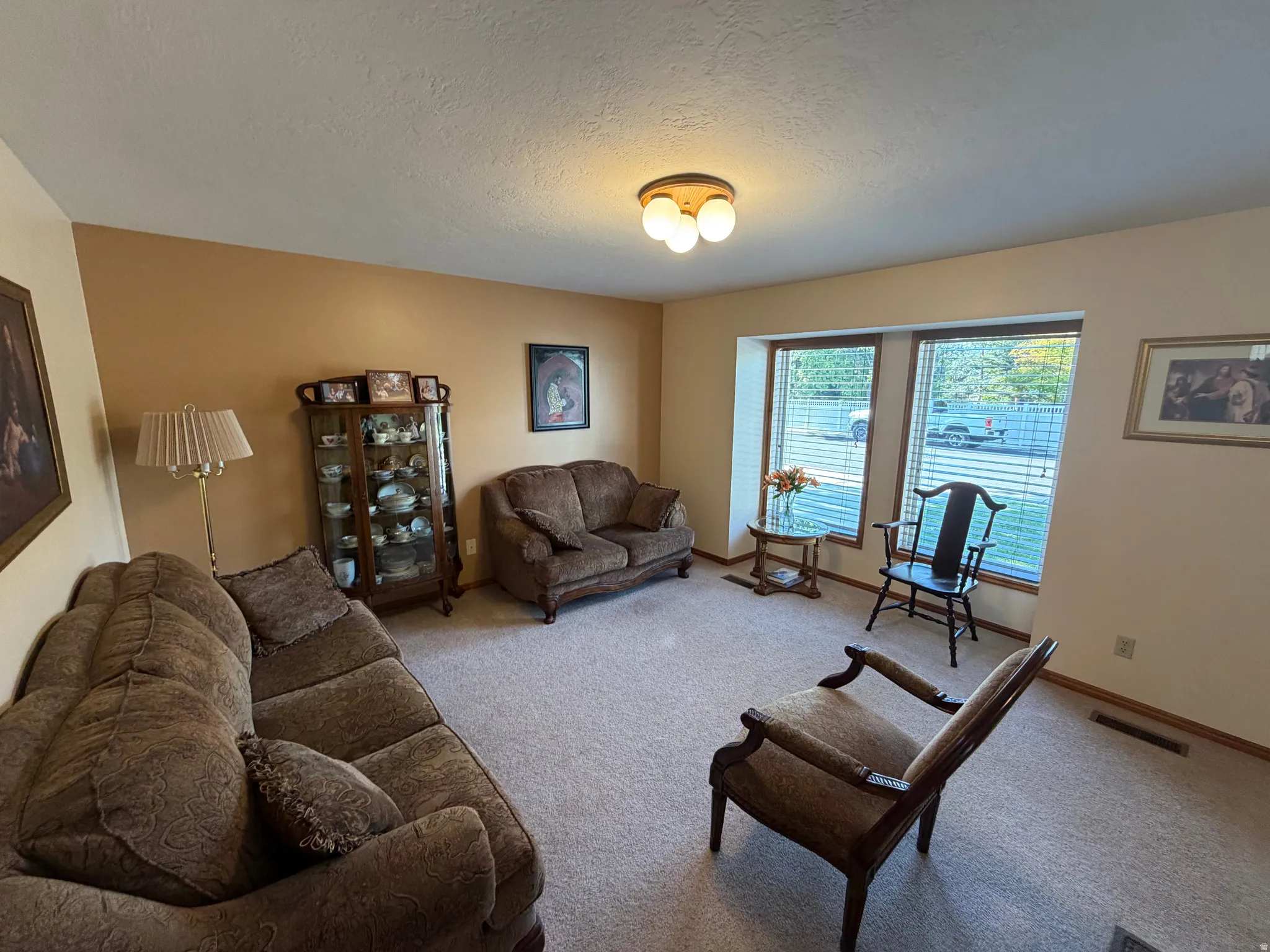 Carpeted interior space featuring light beige and ochre walls