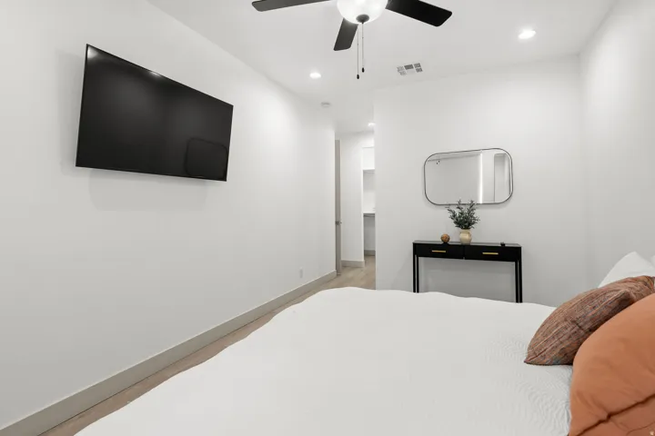 Bright interior space featuring recessed lighting, a ceiling fan, wood-finish flooring, and white baseboards
