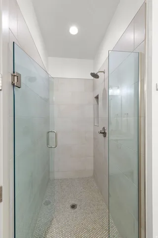 Walk-in shower with clear glass enclosure