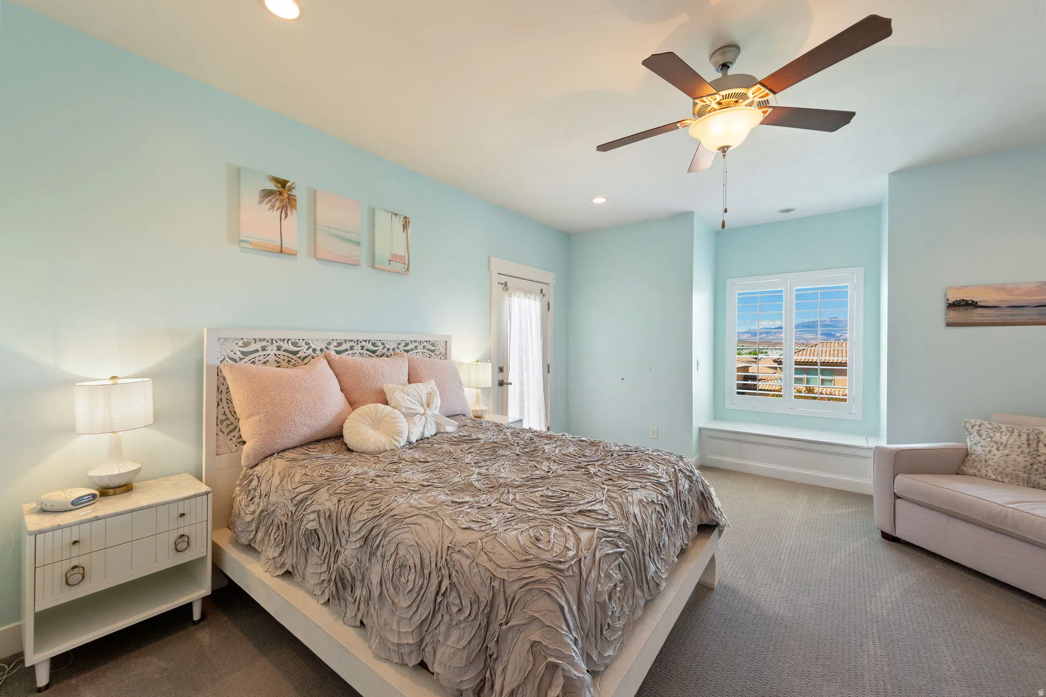 Bright room featuring light blue walls and neutral carpet flooring