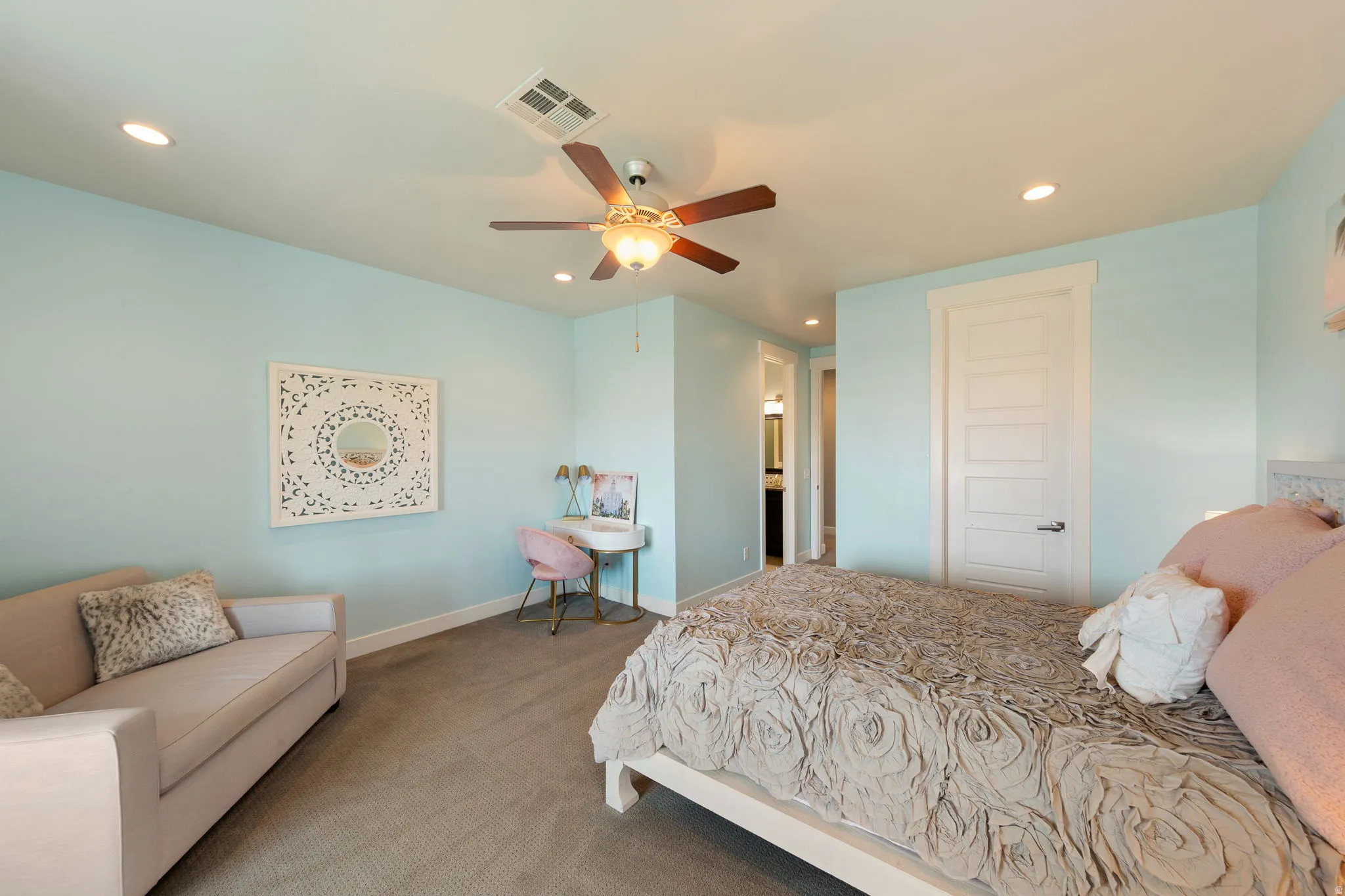 Carpeted bedroom with a ceiling fan, recessed lighting, and a five-panel interior door
