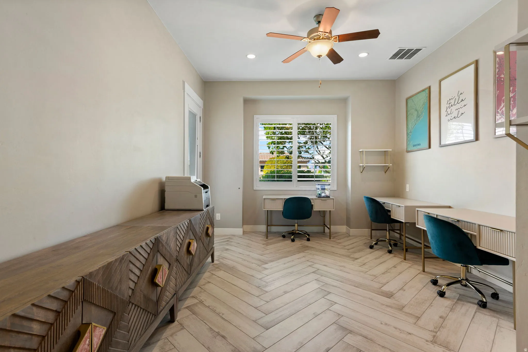 Room featuring herringbone wood-finish flooring, recessed lighting, and a ceiling fan