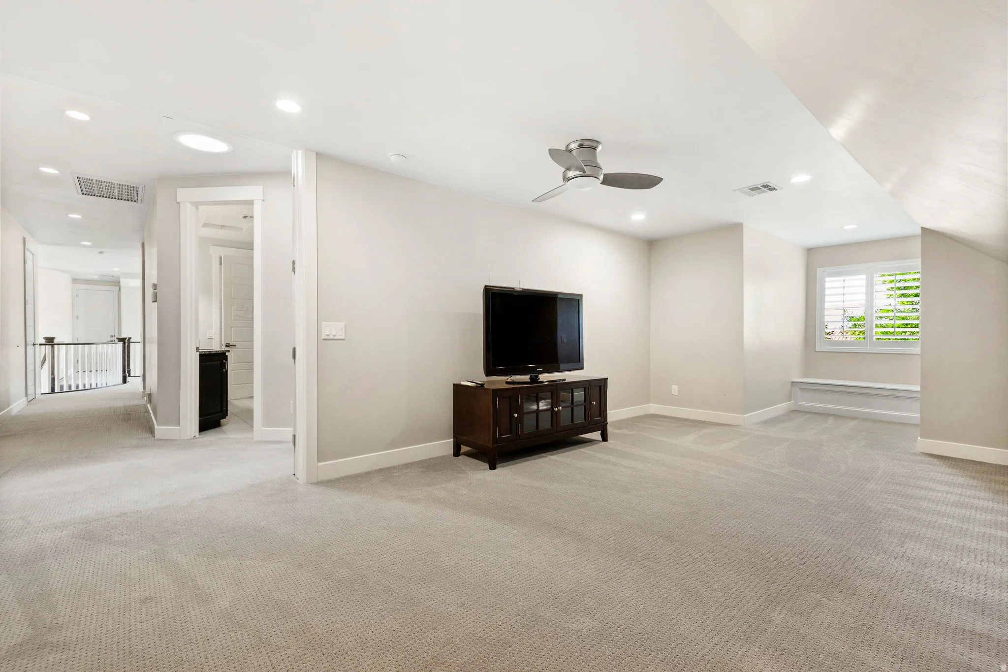 Open concept bonus room featuring light-toned carpeting, recessed lighting, and a modern ceiling fan