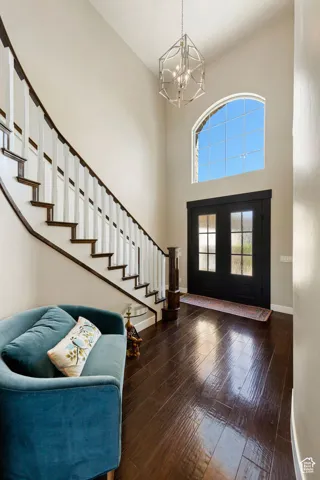 Grand entryway with a soaring ceiling and wood-finish flooring