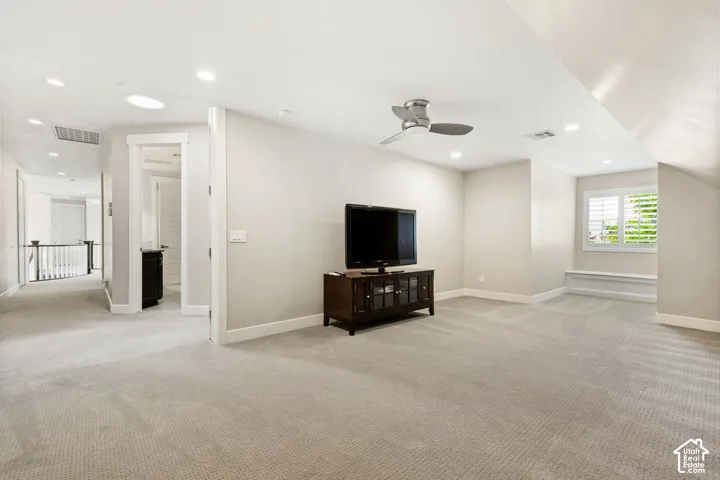 Open concept bonus room featuring light-toned carpeting, recessed lighting, and a modern ceiling fan