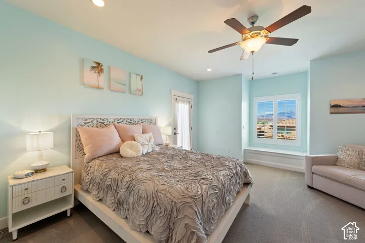 Bright room featuring light blue walls and neutral carpet flooring