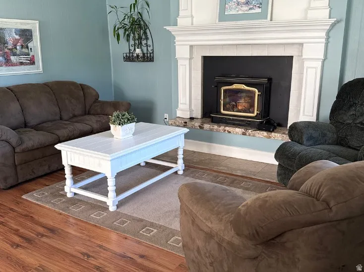 Living space featuring a prominent fireplace with a custom white mantel