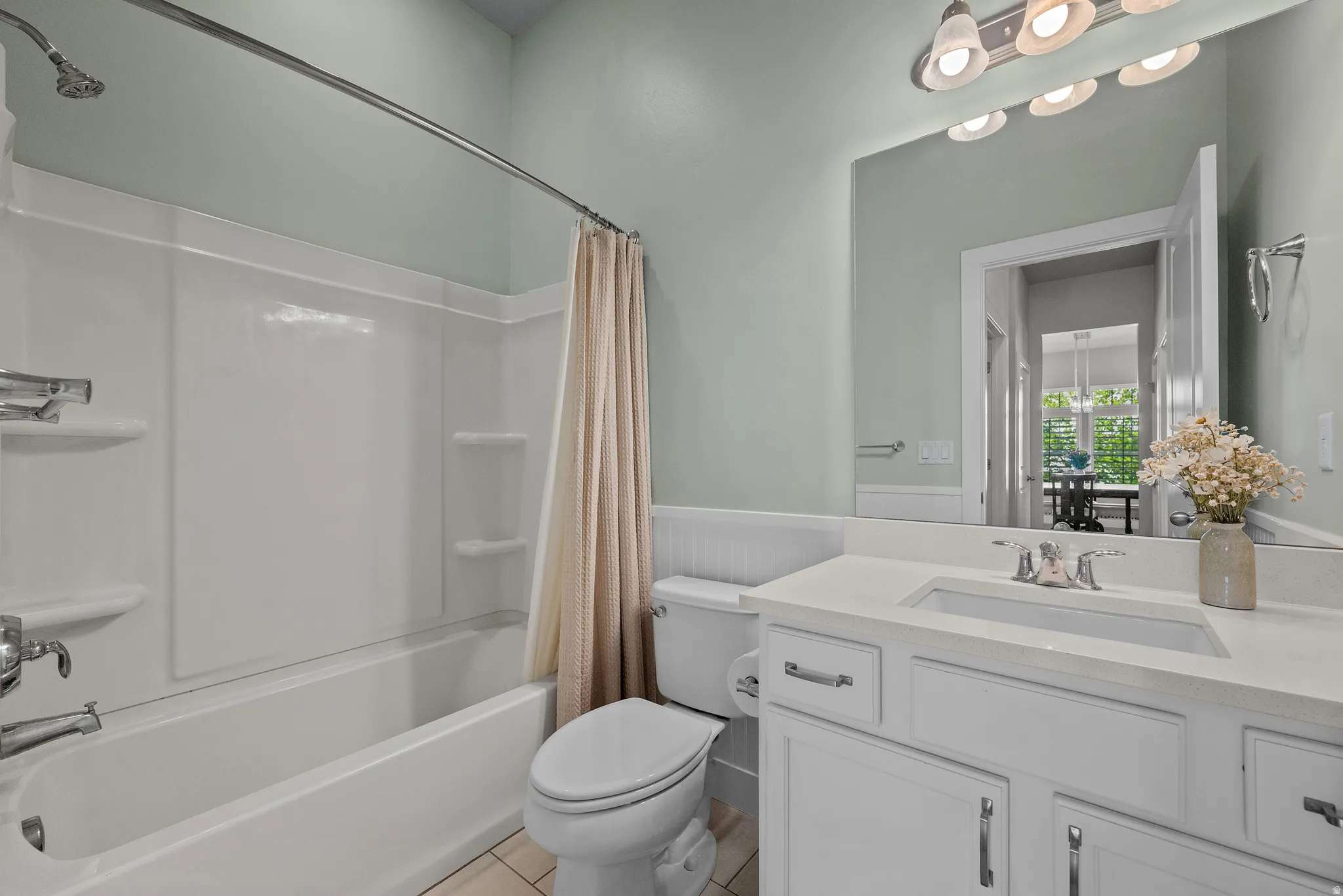 Bathroom featuring a white vanity with a light-colored countertop, an undermount sink, and chrome fixtures