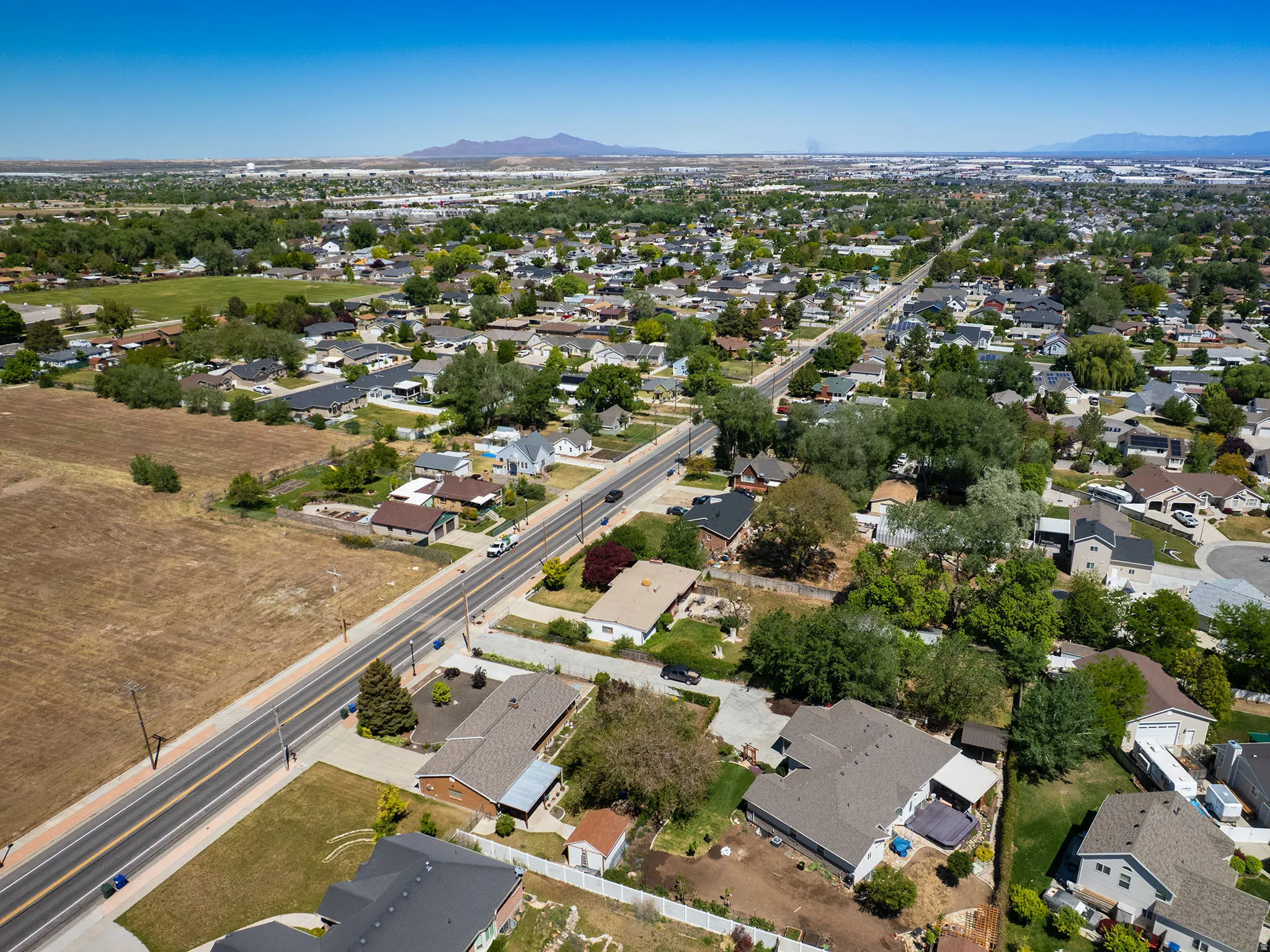 Aerial perspective showcasing a residential area with varied housing styles and mature landscaping