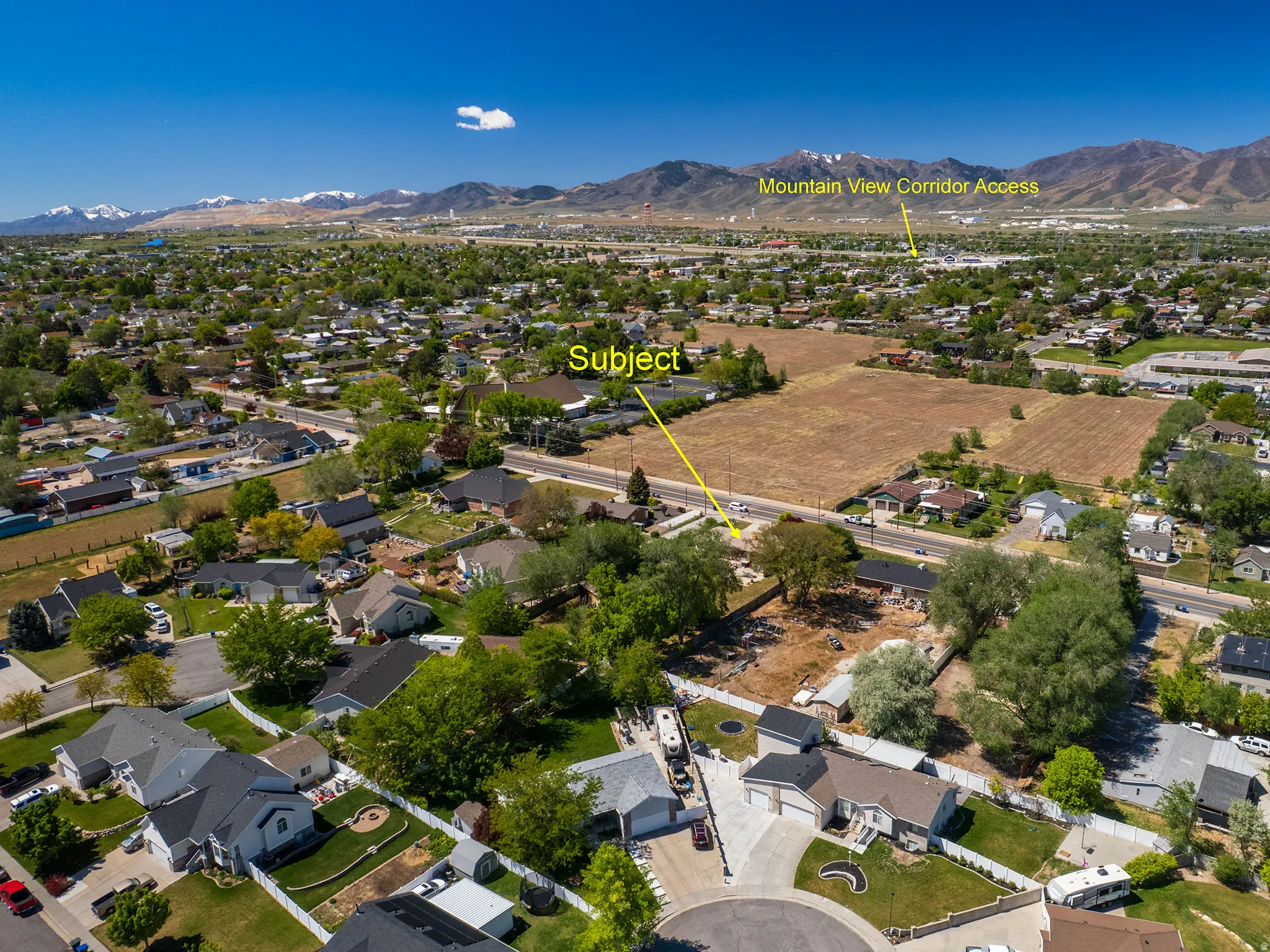 Aerial perspective showcasing a residential area with undeveloped land