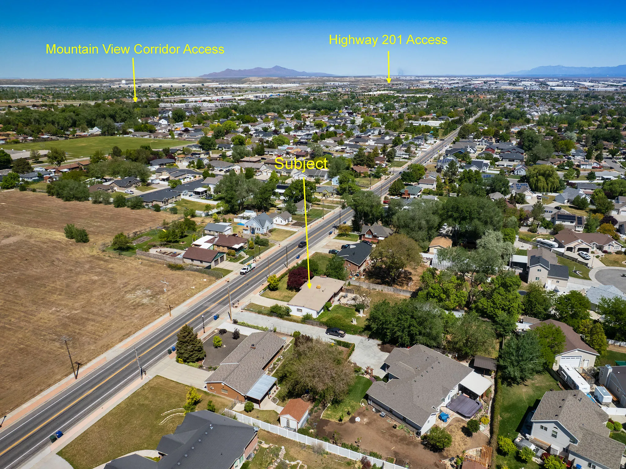 Aerial perspective showcasing a residential area with varied housing styles and mature trees
