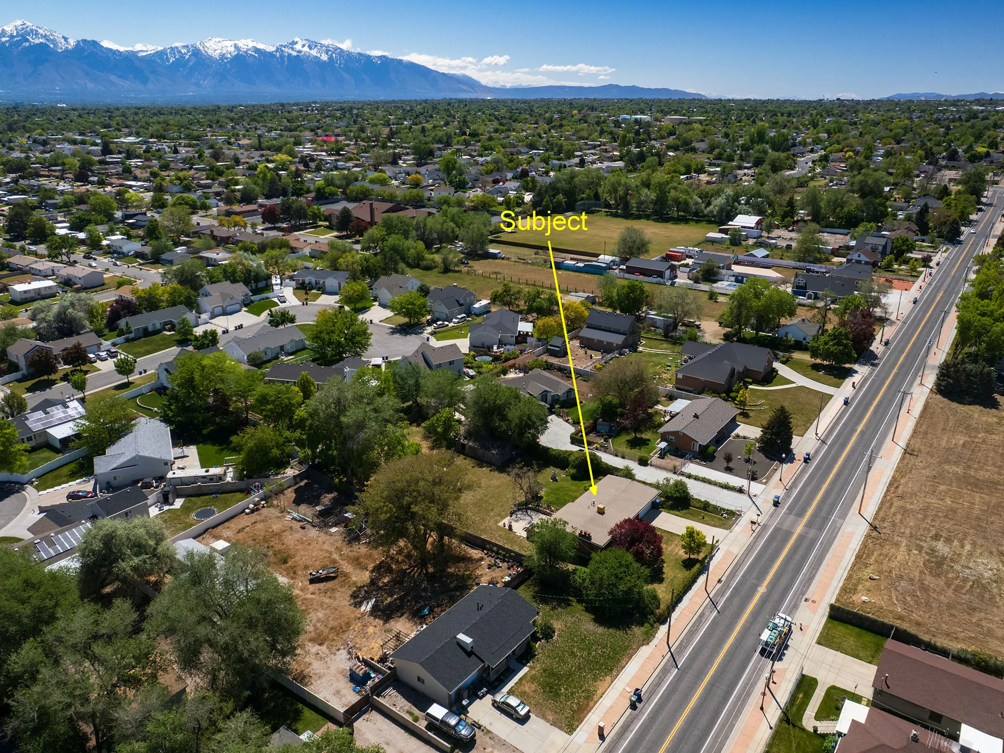 Aerial overview showcasing the property's location within a residential area with established trees and street access