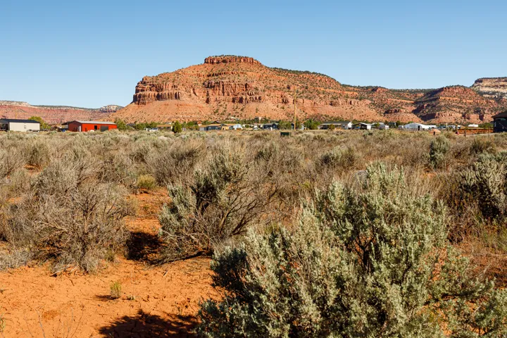 Expansive land parcel featuring native desert shrubs and reddish-brown soil