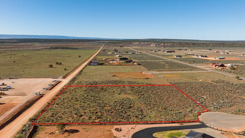 Expansive undeveloped lot featuring natural desert vegetation, a level topography, and clear boundaries outlined in red