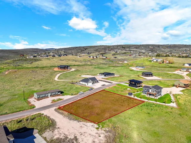 Generous undeveloped lot featuring a level building area, direct road frontage, and surrounding natural landscaping