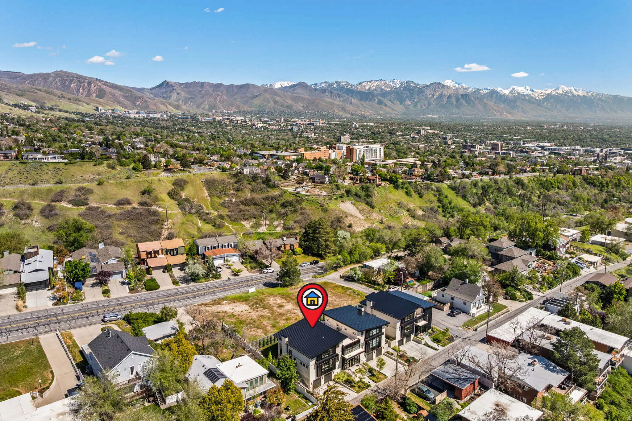 Aerial perspective showcasing modern townhomes with flat roofs and dark exteriors