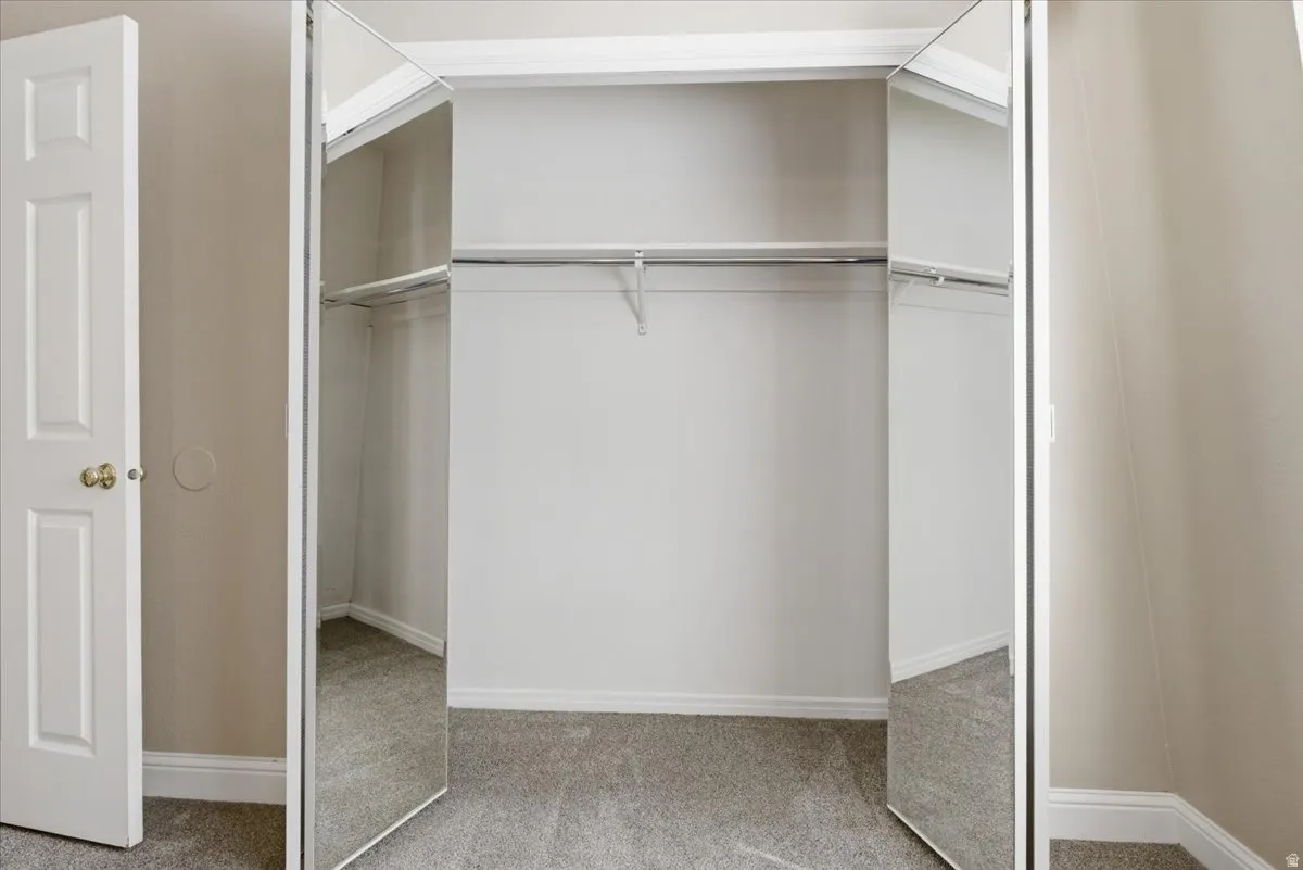 Mirrored bi-fold closet doors with white trim
