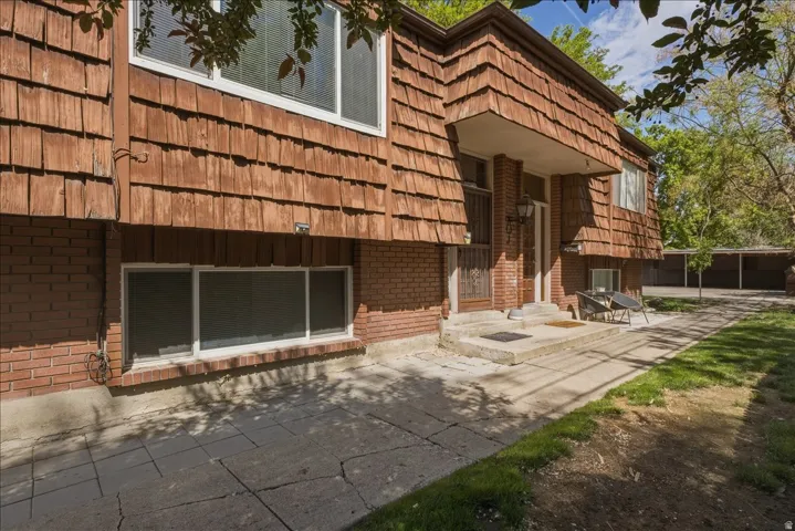 Split-level exterior featuring cedar shake siding and brick accents