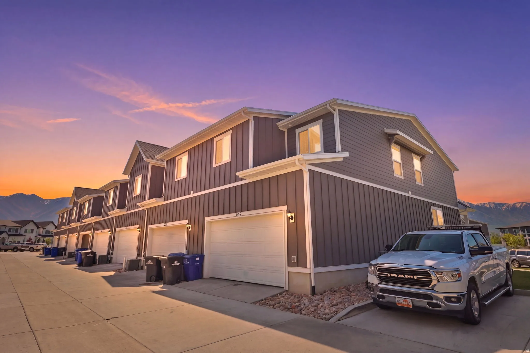 Modern townhome exterior featuring contemporary dark gray siding and white trim