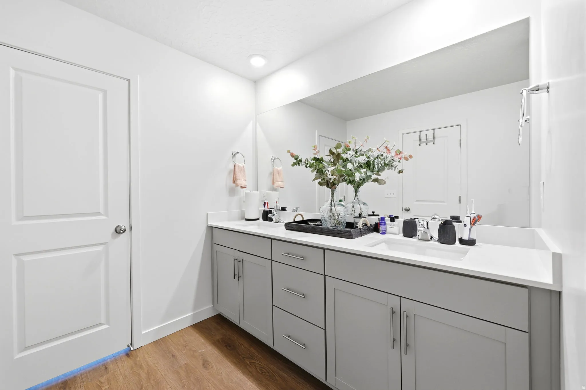 Double vanity featuring light gray cabinetry, brushed nickel hardware, and white countertops
