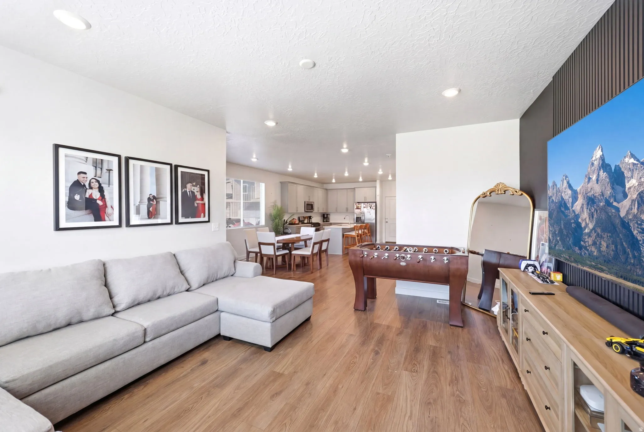 Open-concept living space featuring wood-finish flooring and recessed lighting throughout