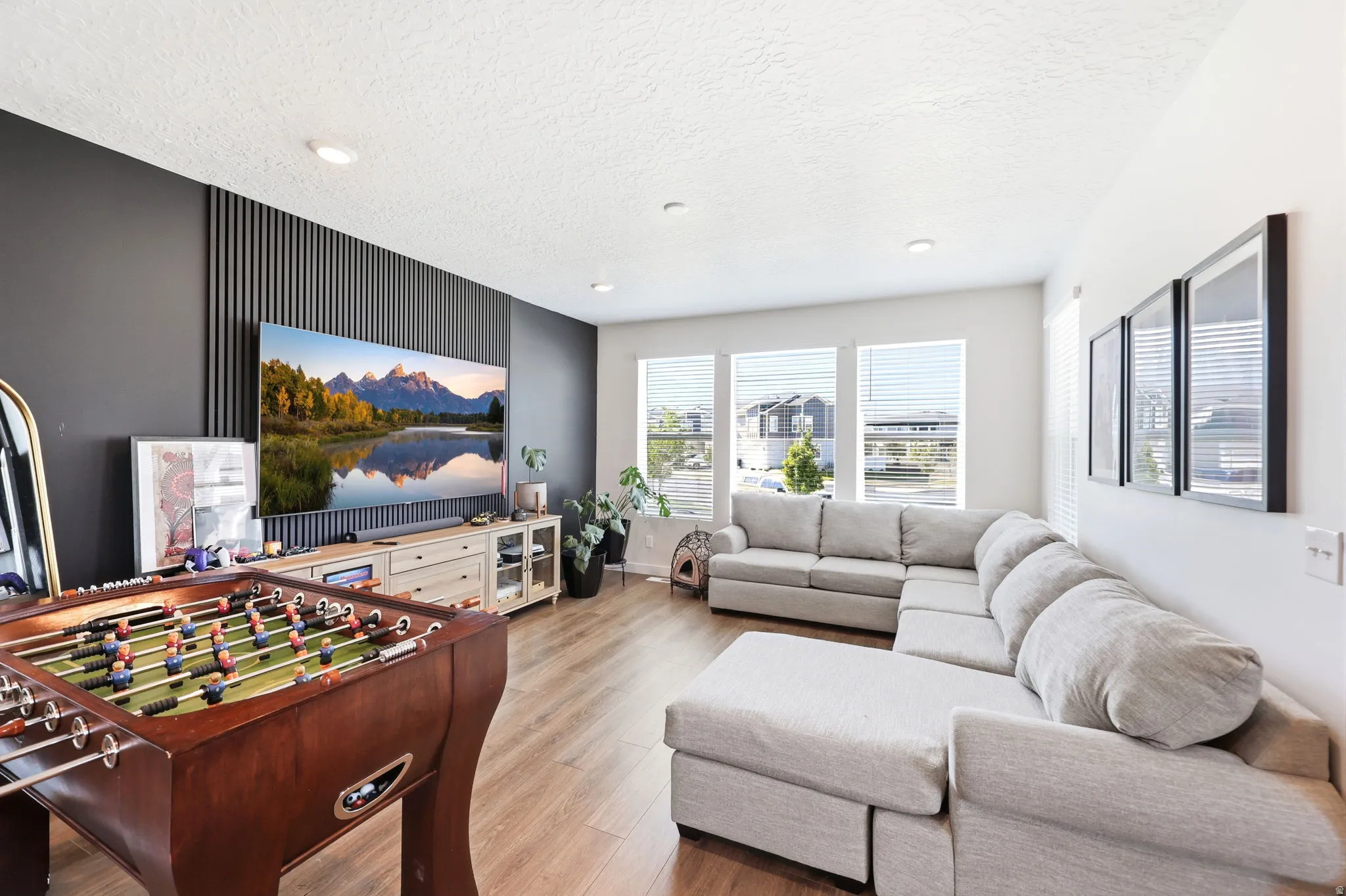 Open-concept living space featuring wood-finish flooring and recessed lighting