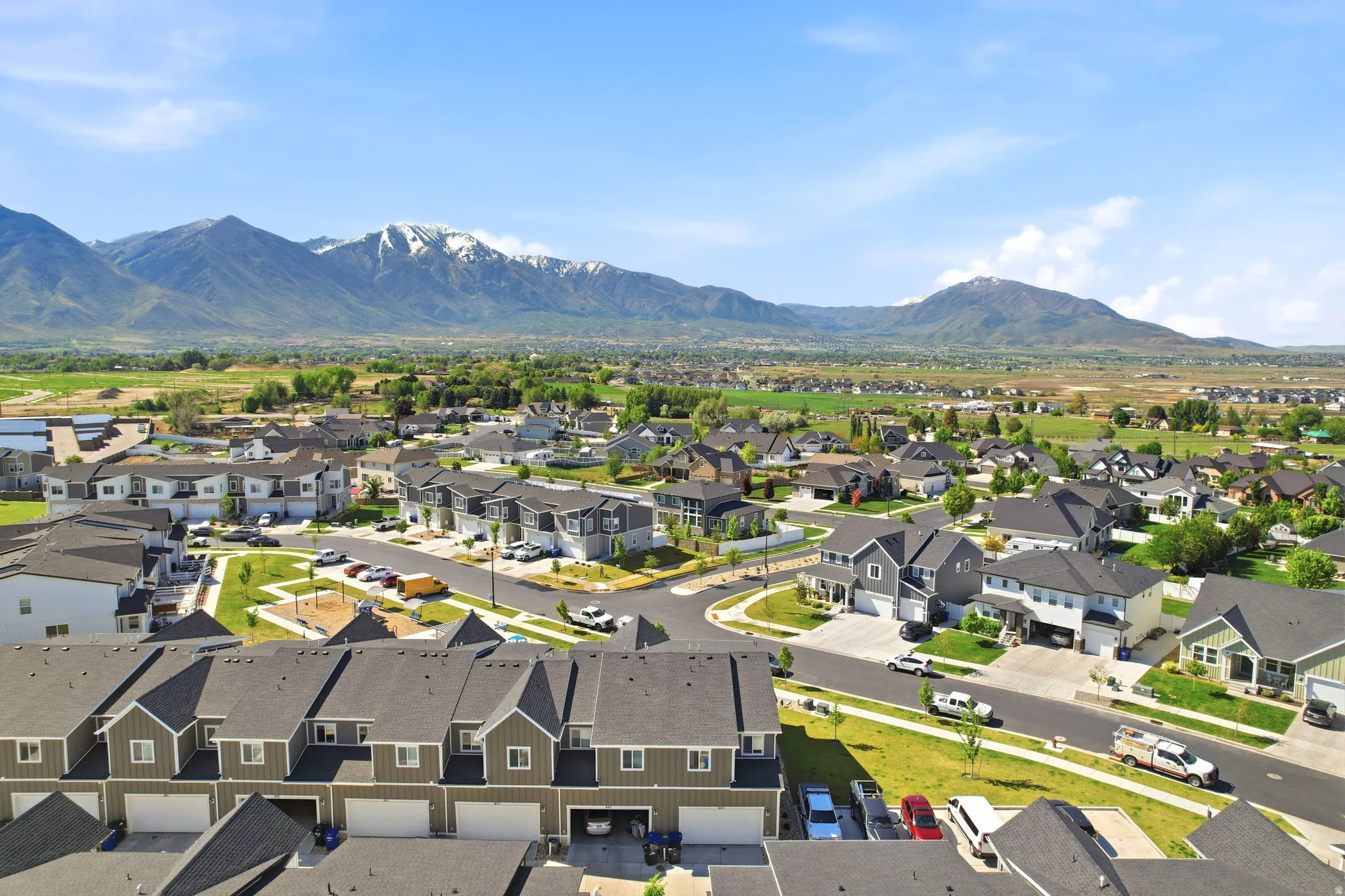 Residential community featuring single-family homes and townhomes with distinct architectural styles