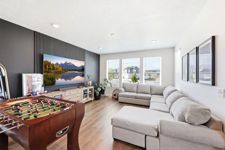 Open-concept living space featuring wood-finish flooring and recessed lighting