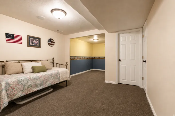 Carpeted room featuring a white paneled door, recessed lighting, and a neutral wall color