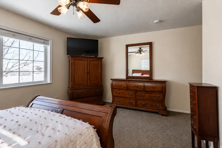 Light-toned walls complement the neutral carpeting