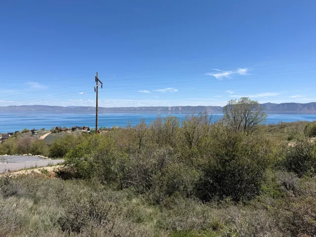Expansive terrain with distant water and mountain scenery