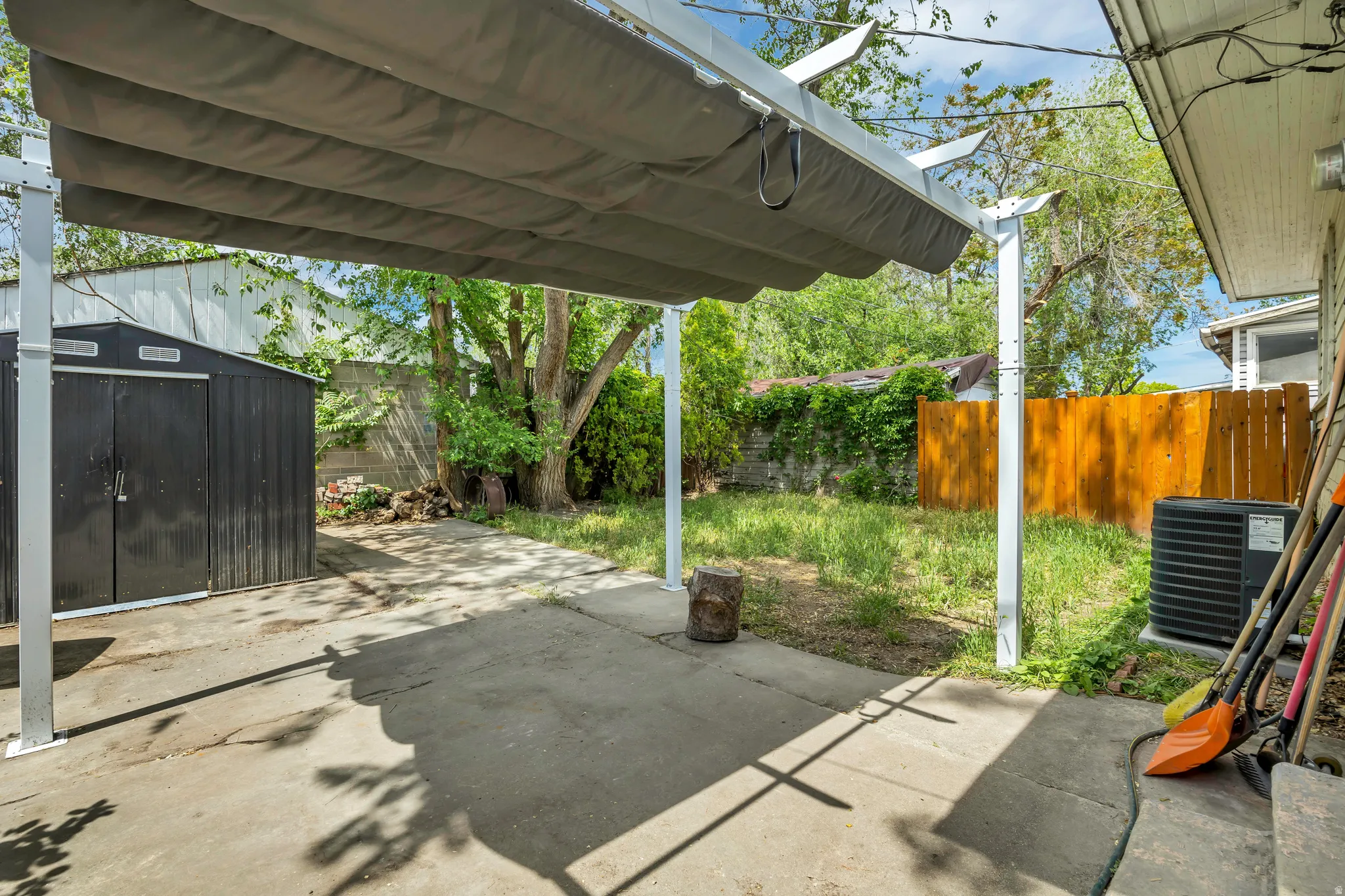 Concrete patio featuring a retractable awning