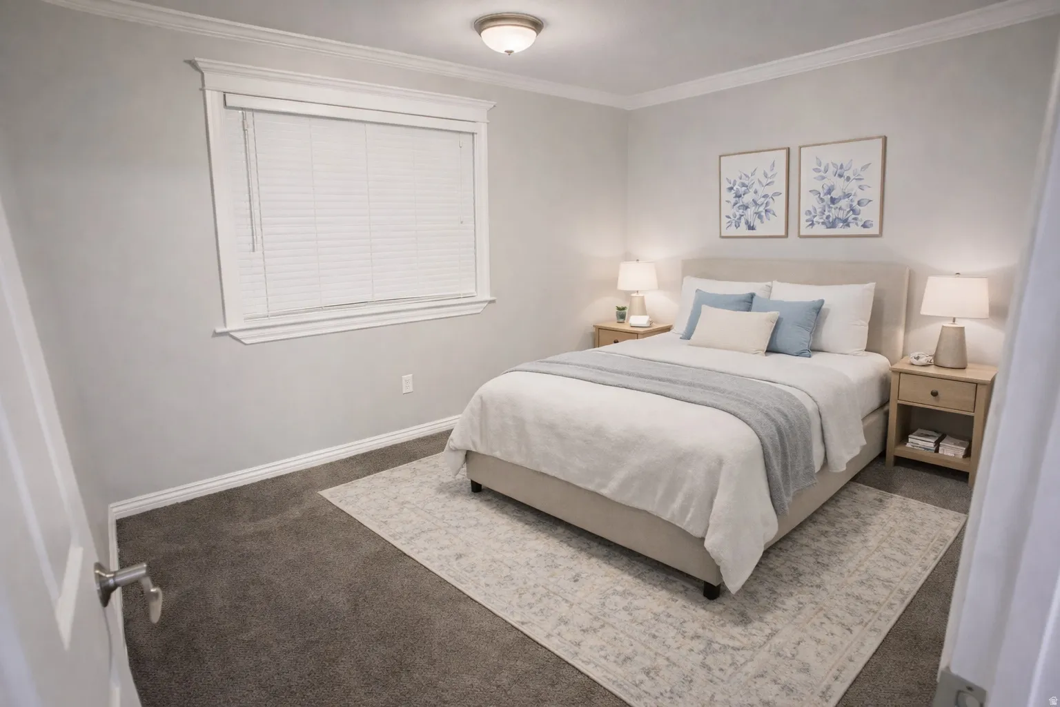 Carpeted room featuring a single window with blinds, crown molding, and baseboards