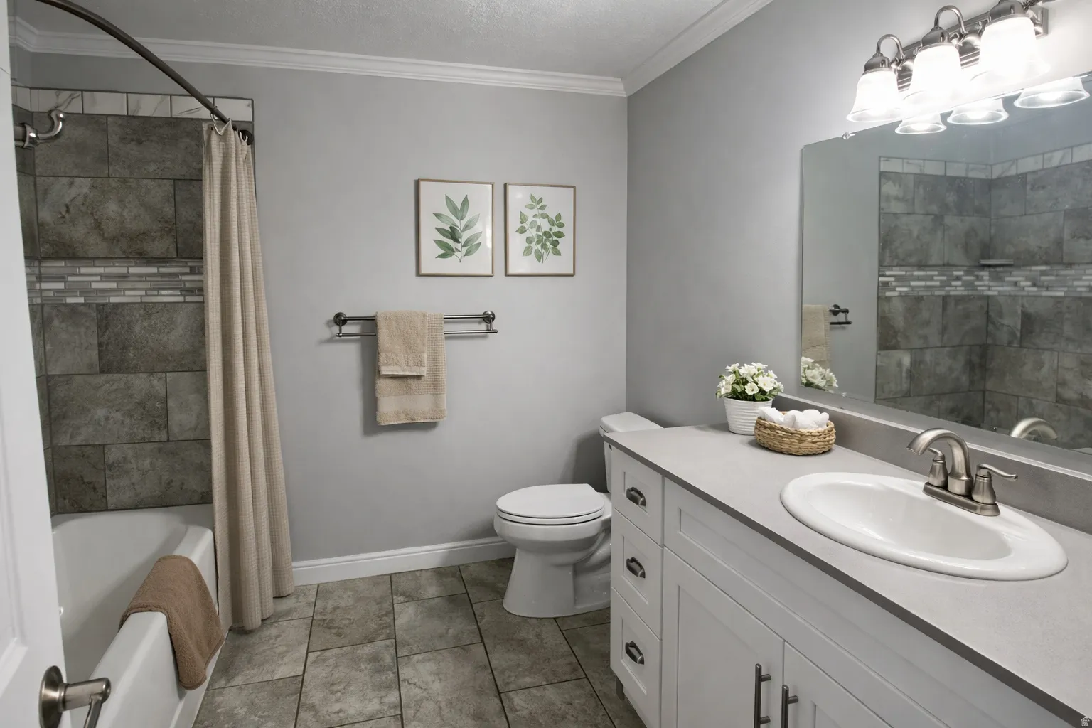 Bathroom featuring a white vanity with silver hardware, a single basin sink, and a large mirror