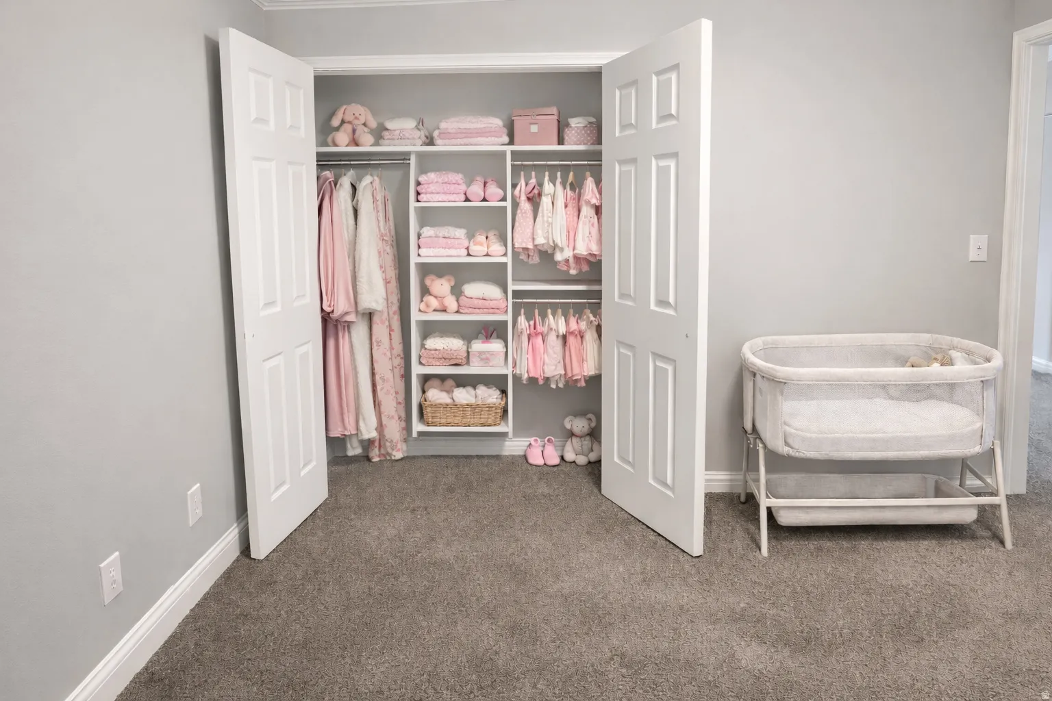 Custom closet organization system featuring white shelving and hanging rods within a bi-fold door closet